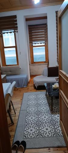 a living room with two windows and a rug at In the Heart of Istanbul in Istanbul