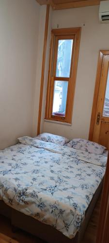 a bed in a room with a window at In the Heart of Istanbul in Istanbul
