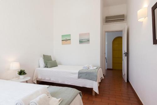 a small room with two beds and a hallway at Aldeia do Golfe - Private condominium by HD in Vilamoura