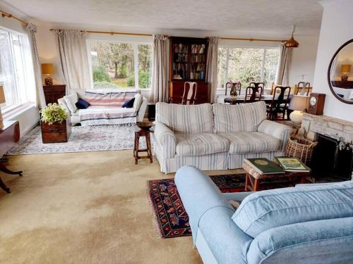 a living room with two couches and a fireplace at Brooklands Farm Hamble Riverside apartment on the reiver in Southampton