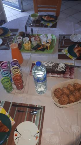a table with food and a bottle of water on it at L'Arche d' Engel in Courpière