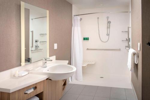 a bathroom with a sink and a shower at SpringHill Suites by Marriott Punta Gorda Harborside in Punta Gorda