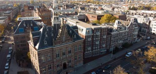 an aerial view of a large building with a clock tower at Pestana Amsterdam Riverside in Amsterdam