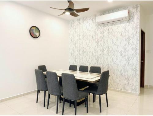 a dining room table with chairs and a ceiling fan at Pangkor Villa88 Double Storey 3min to Pasir Bogak Beach in Pangkor