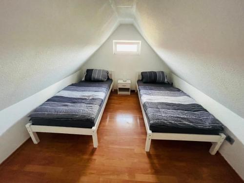 two beds in a room with a attic at Pension Helga in Dessau