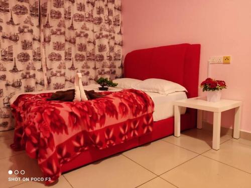 a red bed with a cat laying on top of it at HP402- Two Bedroom Apartment- Wifi- Netflix- Parking- Cyberjaya -New, 3061 in Cyberjaya