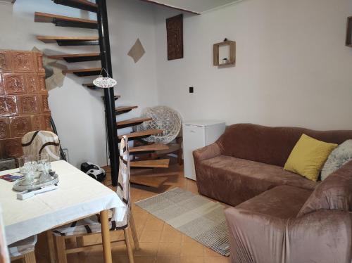 a living room with a couch and a table at Sárga Liliom Vendégház in Cserépfalu