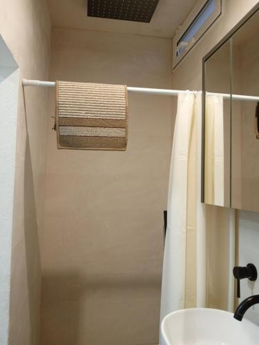 a bathroom with a shower with a sink and a towel at Rooms Burjassot in Burjassot