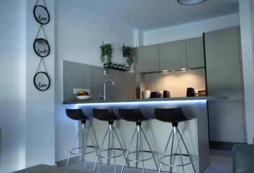 a kitchen with a counter with stools in it at Lovely cozy one bedroom suite with pool in Protaras