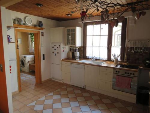 a kitchen with a sink and a stove top oven at Landhausstil trifft Moderne in Muhlheim am Main