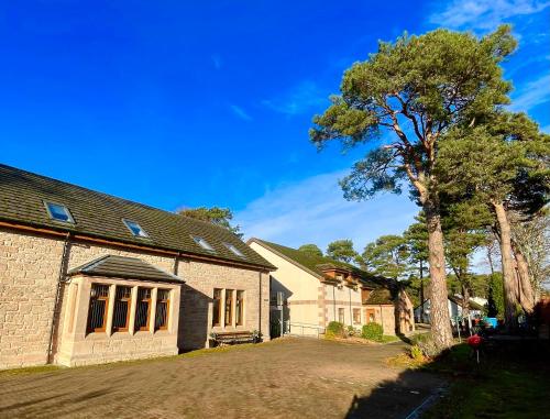 a house with a tree in the driveway at Talisker in Nairn