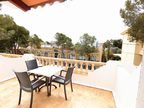 a patio with a table and chairs on a balcony at Don Carlos in Paguera
