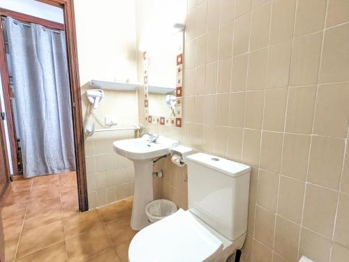 a bathroom with a toilet and a sink at Don Carlos in Paguera