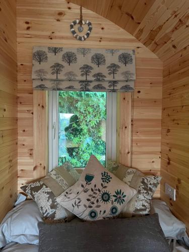 A bed or beds in a room at A Unique & Tranquil Smallholding Retreat