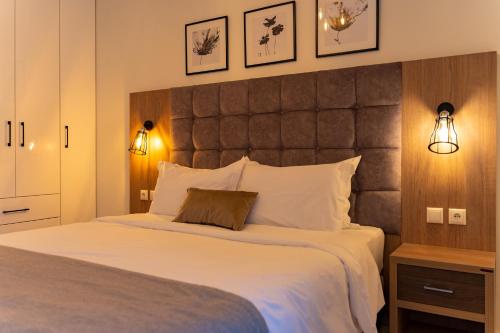 a bedroom with a large bed with a large headboard at Ideal House in Parga