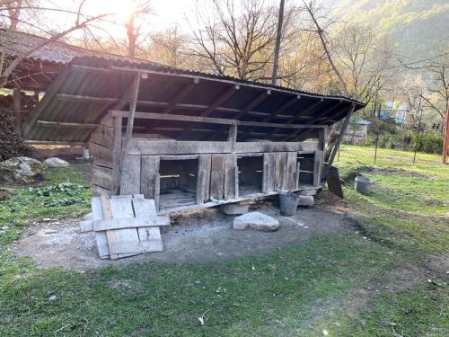 a wooden shed with a roof in a field at Sim Guesthouse in Sım