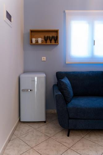 a living room with a chair and a small refrigerator at Ideal House in Parga