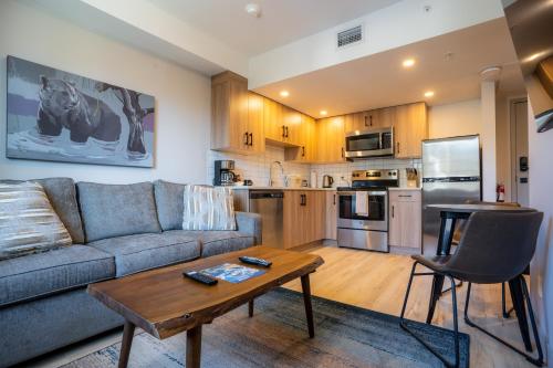 a living room with a couch and a table at Basecamp Suites Banff in Banff