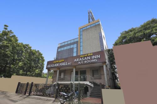 a building with a motorcycle parked in front of it at Capital O Jayam Residency in Chennai