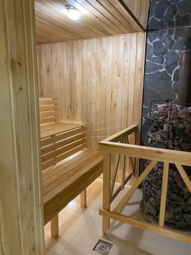 a sauna with a wooden bench in a room at Smerekovyi Dvir in Polyana