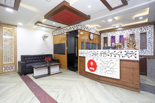 een lobby met een zwarte bank en een tafel bij OYO Hotel Shanti Palace in Sikandra
