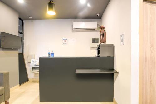 a kitchen with a counter and a refrigerator at Collection O Jps Grand Hotel Near Dwarka Metro Station in New Delhi