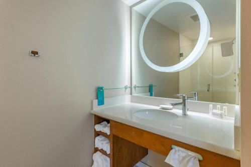 y baño con lavabo y espejo. en SpringHill Suites Vero Beach, en Vero Beach