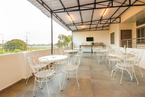 a group of tables and chairs on a balcony at Super Townhouse RCC Sunrise in Hyderabad