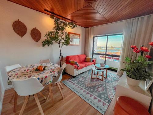 a living room with a table and a couch at Hostel Aveiro in Aveiro