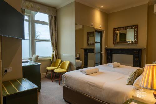 a hotel room with a bed and a mirror at Burlington House Boutique in Oxford