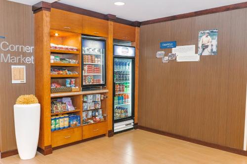 a store aisle with a refrigerator and a grocery store at Fairfield by Marriott Medford Long Island in Medford
