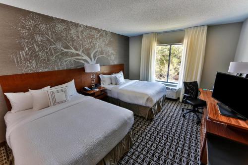 a hotel room with two beds and a television at Fairfield Inn & Suites by Marriott Savannah Midtown in Savannah