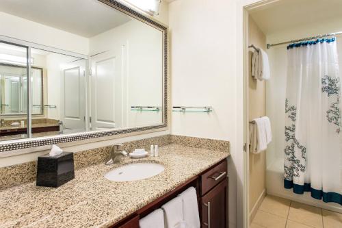 a bathroom with a sink and a mirror at Residence Inn San Diego Oceanside in Oceanside