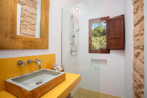 a bathroom with a sink and a shower at Can Font in Santa Eularia des Riu