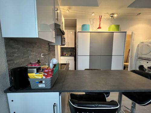 a kitchen with a table and two chairs in it at Pension des Draizes in Neuchâtel