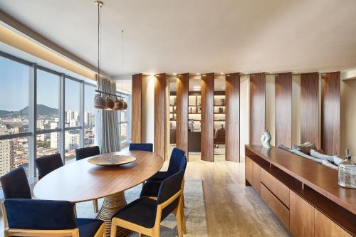 a dining room with a table and chairs at Sheraton Santos Hotel in Santos