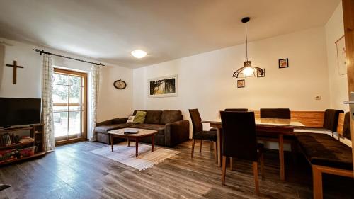 a living room with a dining table and a couch at Dorfhof Bauer in Riegersburg