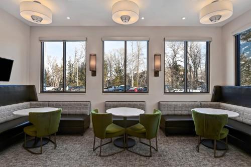 a waiting room with tables and chairs and windows at Residence Inn Steamboat Springs in Steamboat Springs
