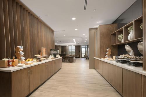 a long hallway with aasteryasteryasteryasteryasteryasteryasteryasteryasteryasteryastery at SpringHill Suites by Marriott Lindale Tyler in Lindale