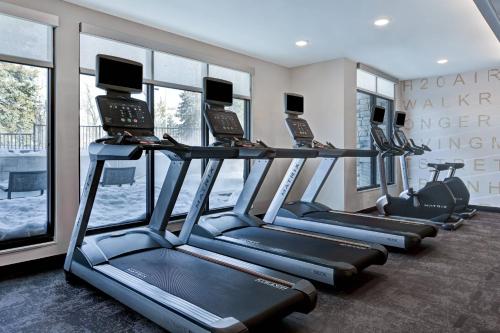 a row of treadmills in a fitness room with windows at Residence Inn Steamboat Springs in Steamboat Springs
