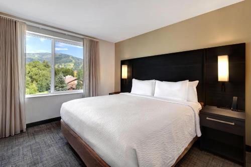 a bedroom with a large bed and a large window at Residence Inn Steamboat Springs in Steamboat Springs