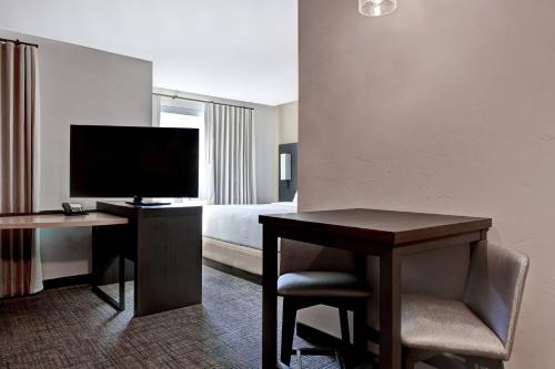 a hotel room with a desk with a television and a bed at Residence Inn Steamboat Springs in Steamboat Springs