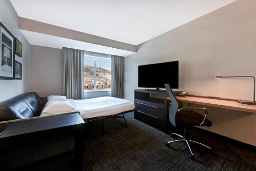 a hotel room with a bed and a desk with a computer at Residence Inn Steamboat Springs in Steamboat Springs