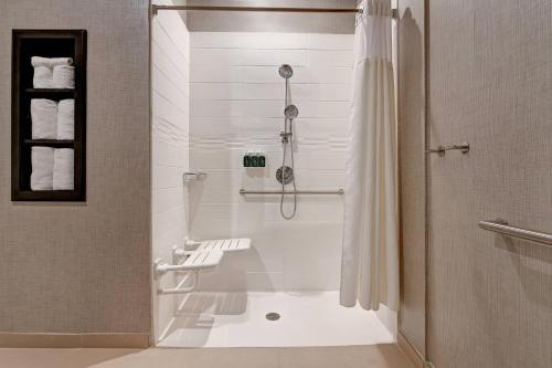 a white bathroom with a shower and a tub at Residence Inn Steamboat Springs in Steamboat Springs