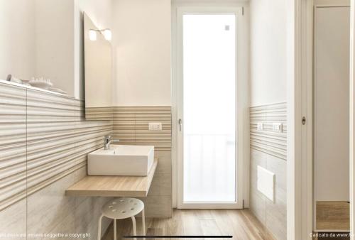 a bathroom with a sink and a mirror at Catalogna10 Rooms in Alghero
