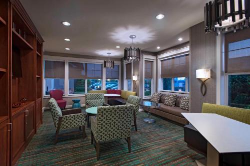 a living room with a couch and a table and chairs at Residence Inn Bryan College Station in College Station