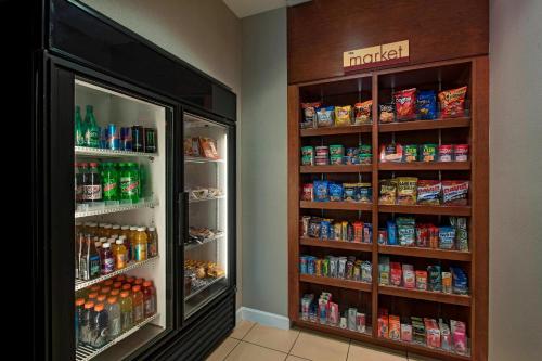 a refrigerator in a store with lots of food at Residence Inn Bryan College Station in College Station