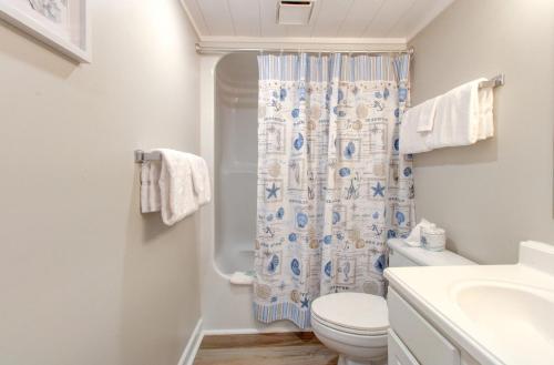 a bathroom with a toilet and a shower curtain at 1010 Relax, Unwind, Enjoy by Atlantic Towers in Carolina Beach