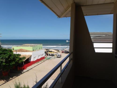 a balcony with a view of the ocean at Hotel Pousada Oasis in Conde