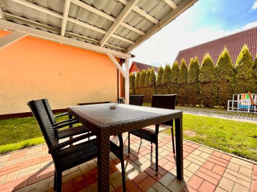a table and chairs sitting on a patio at Pokoje Nad Klifem in Trzęsacz
